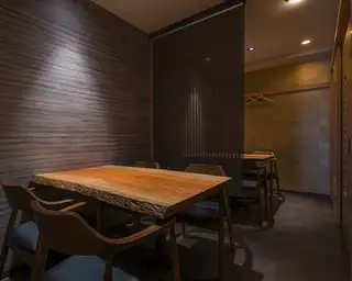 Semi-private room with 2 tables seating 4 people each.
