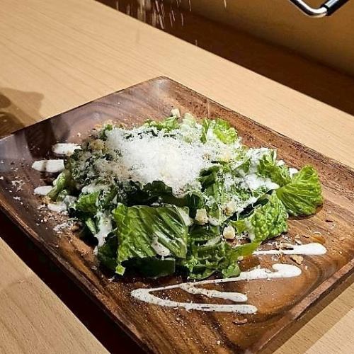 目の前でかけるパルミジャーノチーズとロメインレタスのシーザーサラダ