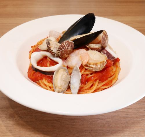 Assorted seafood in tomato sauce (shrimp, scallops, squid, clams, mussels)