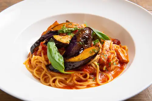 Eggplant, bacon, and basil in tomato sauce