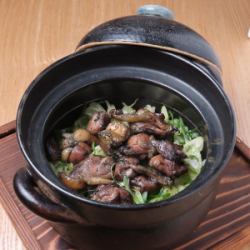 Fukushima-produced Date chicken (black chicken) rice cooked in an earthenware pot.