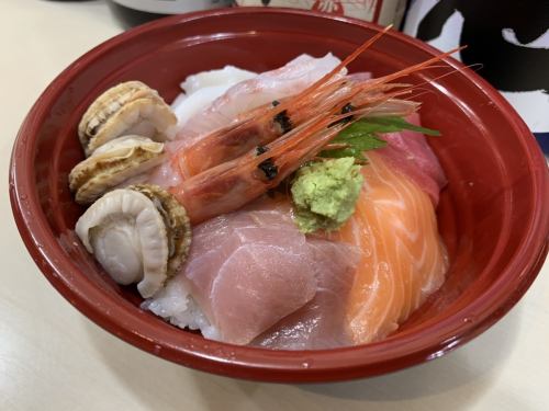 Bowl of rice topped with sashimi