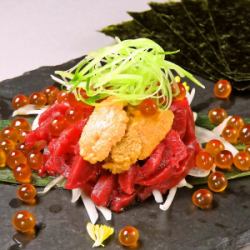 Raw sea urchin and horsemeat sashimi wrapped in seaweed and salmon roe spilled