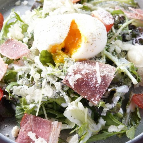 Caesar salad with soft-boiled eggs and crispy bacon
