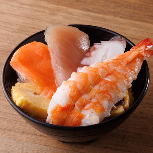 Bowl of rice topped with sashimi