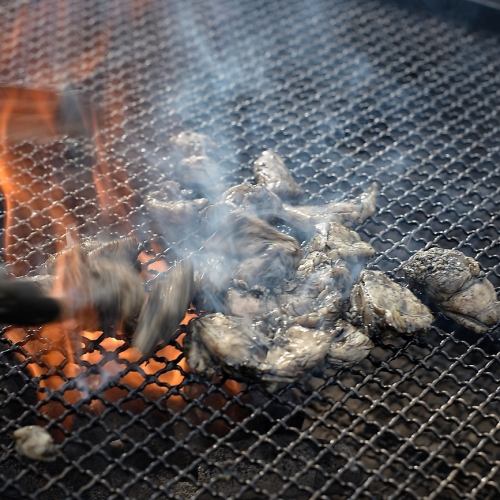 Grill branded chicken over charcoal