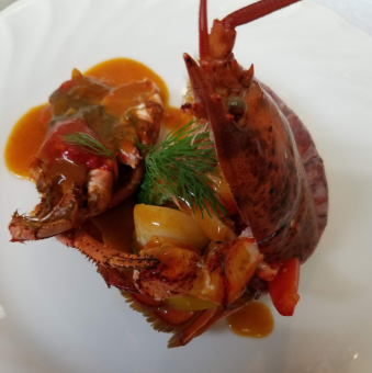 Pan-fried live Canadian lobster with sauce Americaine