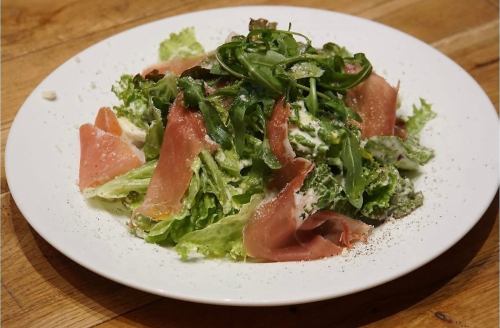 Caesar salad with fresh vegetables and prosciutto with a great texture