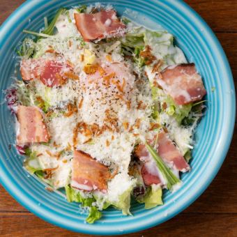 Caesar salad with soft-boiled egg and bacon