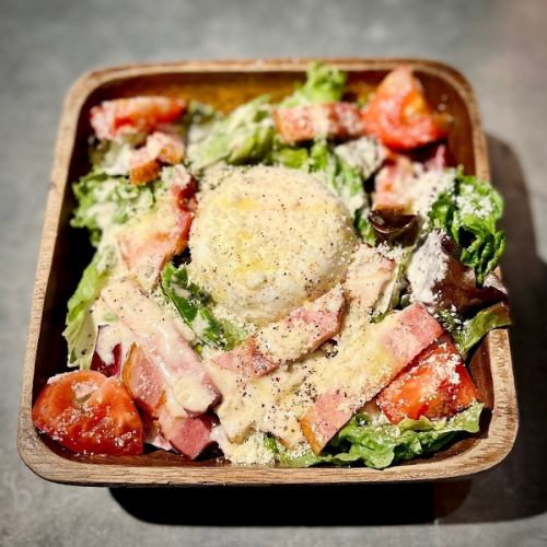Caesar salad with grilled bacon and poached eggs