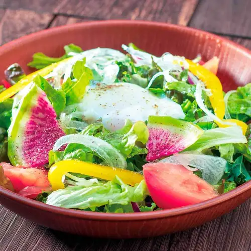 Green salad with soft-boiled egg
