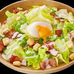 Caesar salad with soft-boiled egg and bacon