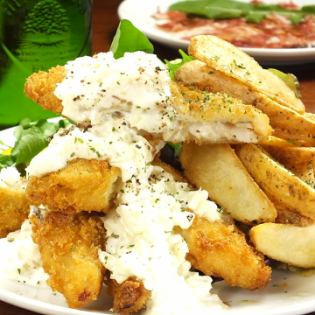 Heap of fish and chips (with potatoes and salad)