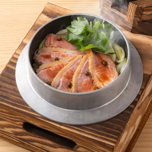 Duck and green onion rice cooked in a pot