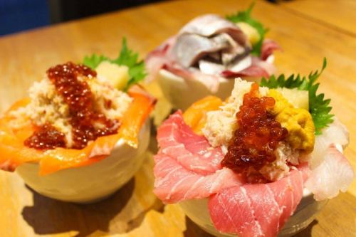 A bowl of rice topped with plenty of toppings! Goes great with sake too!