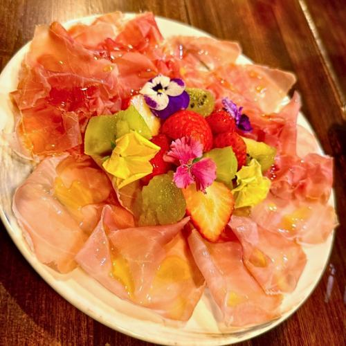 Two kinds of freshly sliced prosciutto and seasonal fruits