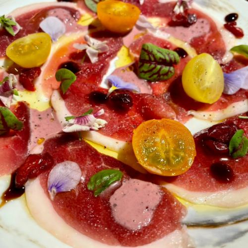 Omi duck breast carpaccio with berry and black pepper sauce