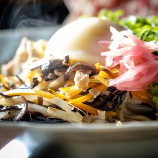 Fried ramen with plenty of spring onions - topped with a soft-boiled egg