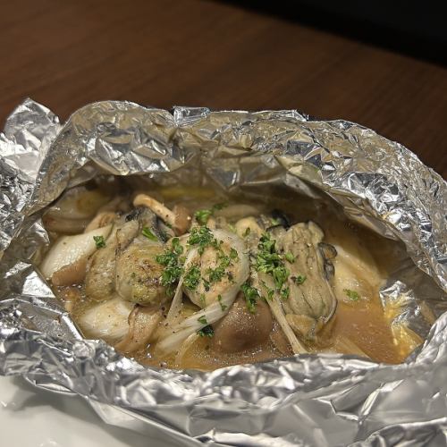 Grilled oysters and mushrooms wrapped in foil