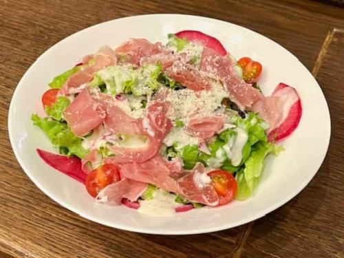 Caesar salad with fresh vegetables and prosciutto with a great texture