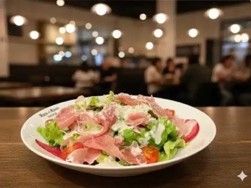 A Caesar salad with fresh vegetables and prosciutto, offering a delightful variety of textures.