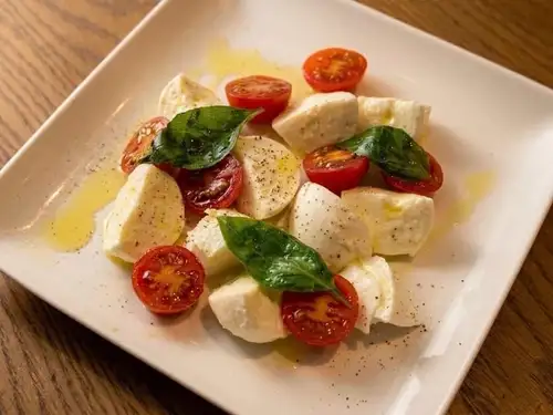 A luxurious Caprese salad with melt-in-your-mouth buffalo mozzarella.