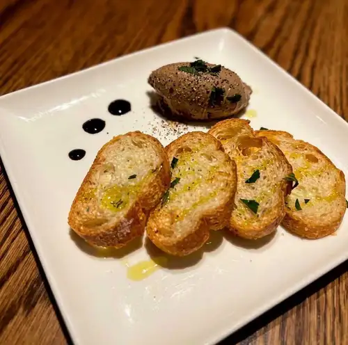 Rich and flavorful chicken liver pâté served with Melba toast.