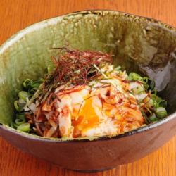 Steamed chicken and daikon radish salad topped with a soft-boiled egg