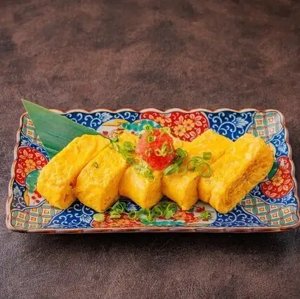 Rolled omelet topped with mentaiko (spicy cod roe)