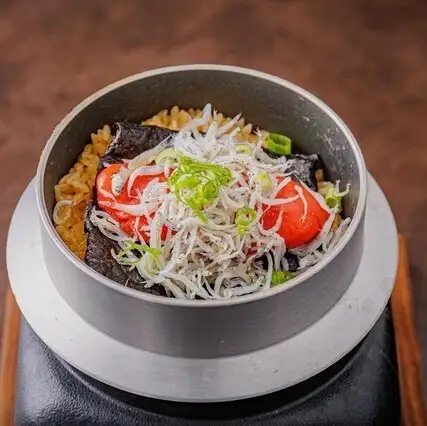 Freshly cooked rice in a pot with mentaiko (spicy cod roe) and shirasu (whitebait)
