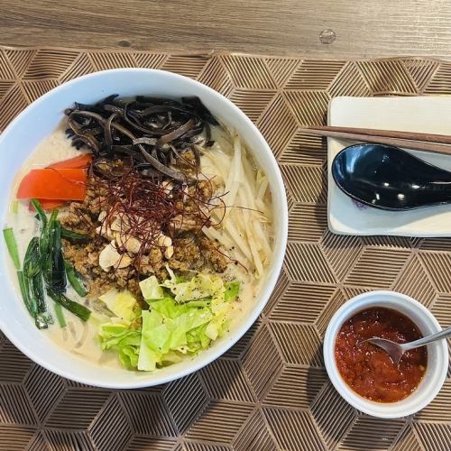 Soy milk vermicelli dandan noodles with tomato chili oil and seasonal vegetables