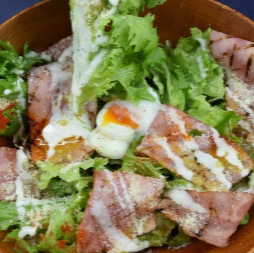 Caesar salad with hot spring egg and grilled bacon