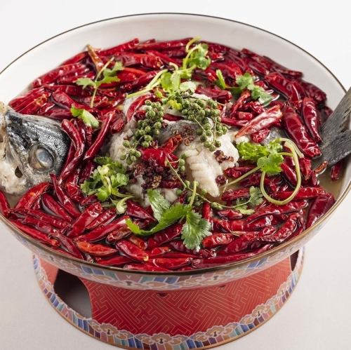 Super spicy grilled fish on an iron plate