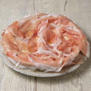 Spilled raw ham protrudes from the plate!