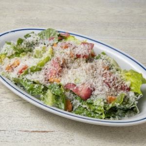 Caesar salad with thick-sliced bacon and romaine lettuce