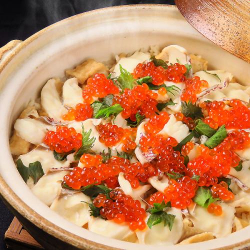 Specially selected seared sea bream in a clay pot topped with salmon roe
