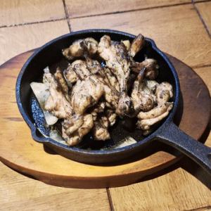 Charcoal-covered grilled chicken neck