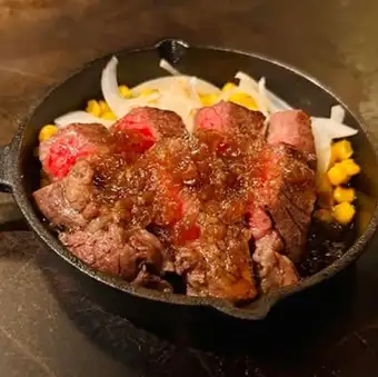 Angus beef steak grilled on a hot plate [with onion sauce]