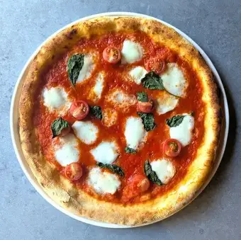 [Tomato] Margherita pizza featuring the queen of buffalo mozzarella cheese