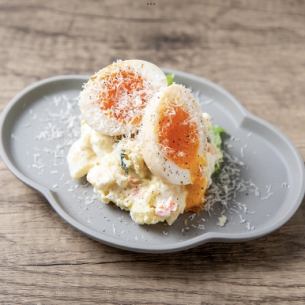 Potato salad with soft-boiled egg and cheese
