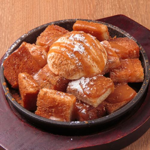 Fried bread topped with vanilla ice cream and salted caramel sauce
