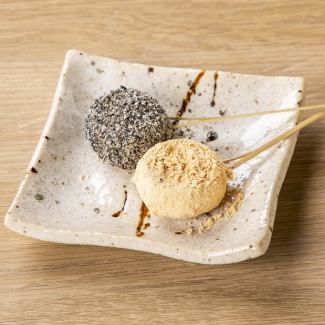 Two types of skewers of dumplings on a hot plate