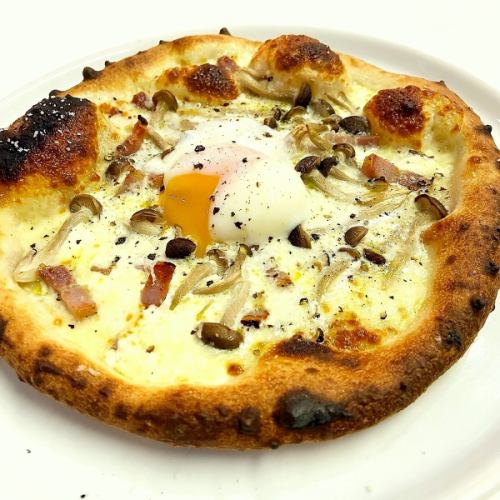Carbonara style pizza topped with soft-boiled egg