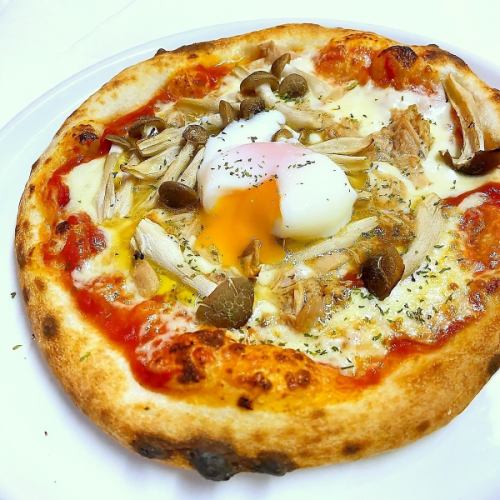 Tuna and mushroom pizza topped with soft-boiled egg