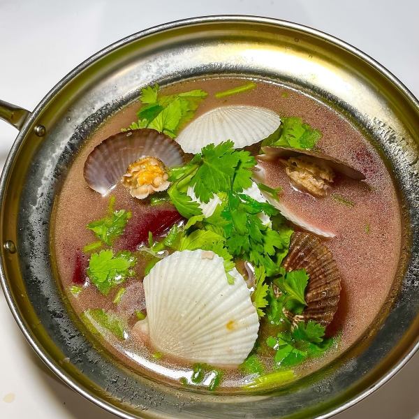 Ethnic herbal soup with young shellfish and beets