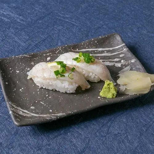 Seared pufferfish nigiri with salt and lemon