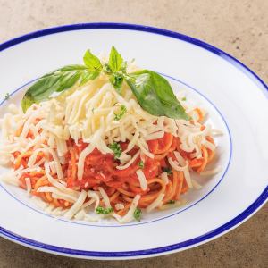 Tomato sauce spaghetti with plenty of cheese and fresh basil