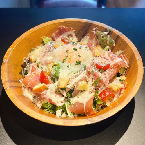 Caesar salad with plenty of prosciutto and cheese