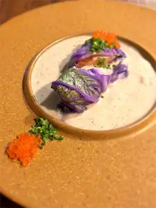 Salmon mi-cuit rolled in napa cabbage with mushroom duxelles sauce