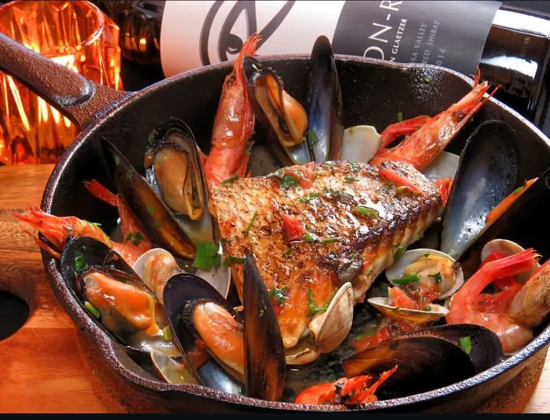 Enjoy the classic Italian fisherman's dish, "Acqua Pazza," with a glass of white wine!